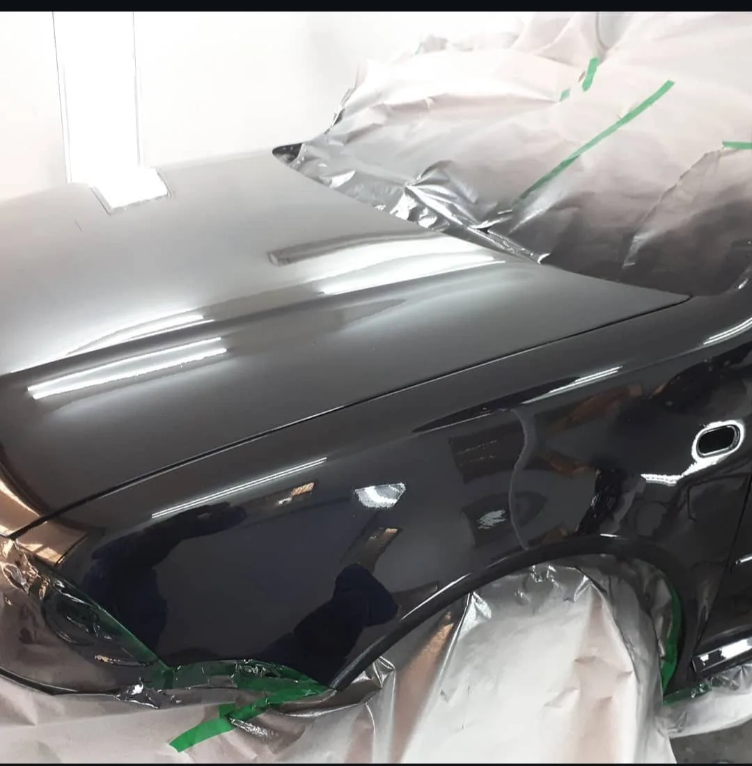 Vehículo enmascarado durante el proceso de pintura en el taller